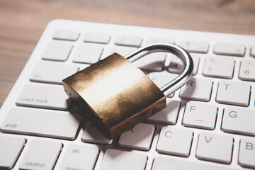 laptop and lock on table, security concept