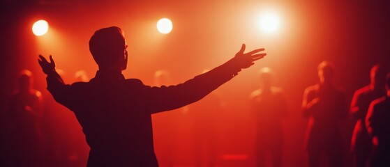 A backlit silhouette of a performer on stage casts an inspiring scene during a dramatic performance, with a warm, captivating glow surrounding.