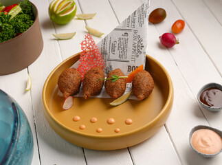 Stuffed meatballs. Kibbeh or Stuffed meatballs white wood background. Middle Eastern cuisine flavors. local name icli kofte