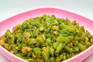 Stir-fried green beans mixed with chicken eggs served on a plate. isolated on white background