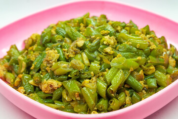 Stir-fried green beans mixed with chicken eggs served on a plate. isolated on white background
