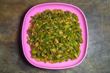 Stir-fried green beans mixed with chicken eggs served on a plate