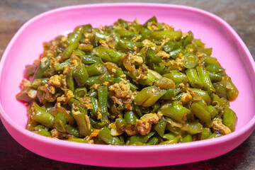 Stir-fried green beans mixed with chicken eggs served on a plate