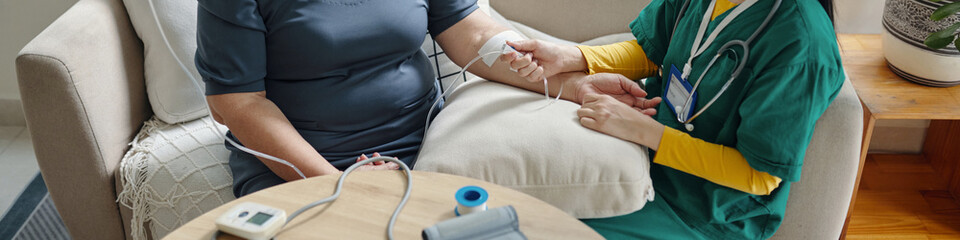 Header with nurse putting iv drip for old woman