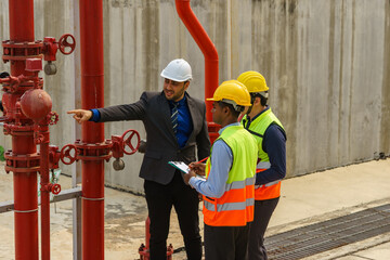 Construction project meeting with workers discussing plans in a modern facility during daylight hours