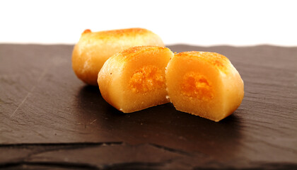 Pastel de yema, candied yolk covered in marzipan, one of many Spanish sweets typically associated with Christmas
