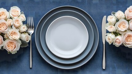 Elegant Table Setting with Romantic Floral Arrangements and Minimalist Dishware on a Textured Blue Background for a Sophisticated Dining Experience