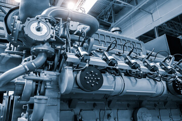 Big gas engine diesel generator electric power with many wires pipes industrial machine concept...