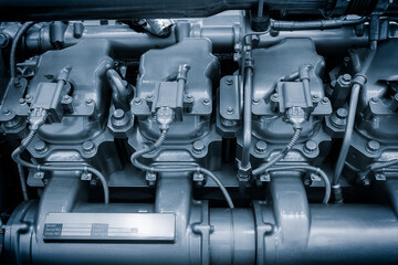 Big gas engine diesel generator electric power with many wires pipes industrial machine concept background