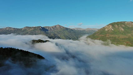 Aerial view of clouds and mountains at sunrise