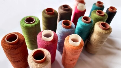 Multi-colored threads on white background for textile industry