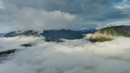 Aerial view of clouds and mountains at sunrise
