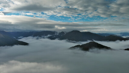 Aerial view of clouds and mountains at sunrise