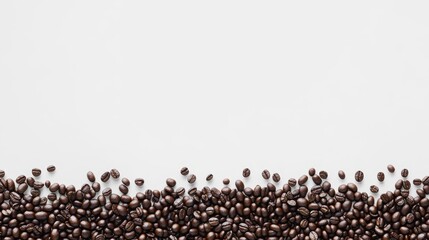 Naklejka premium Brown Coffee Beans Spread Across a White Surface Creating a Minimalist Background for Coffee Lovers and Food Enthusiasts