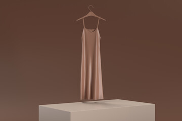 A dress is hanging on a hanger on a brown background