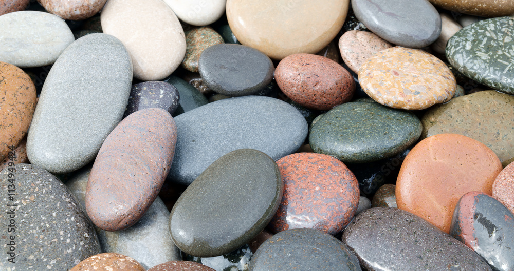 Poster A pile of rocks with different colors. Some are gray, some are brown, and some are red as background