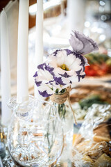 Wedding table decoration with flowers and candles. The elegant wedding table for guests. Stylish table set for wedding dinner