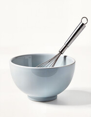 Minimalist Ceramic Bowl and Steel Whisk on White Background with Copy Space
