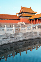 The palace of the Forbidden City in Beijing, where the fence forms a reflection in the water.