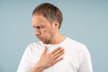 Unhealthy man difficult breathing, holding chest with pain feels symptoms of respiratory distress, cardiovascular heart issues. Unwell middle aged male suffers ache. Heart attack, asthma, pneumonia.