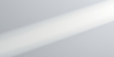 A gentle diagonal beam of light casts a soft shadow across a white background, creating a subtle interplay of light and shadow.