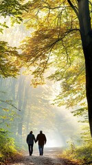 Couple holding hands walking in autumn forest path.