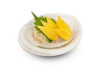 Japanese tamago sashimi (sweet omelette) served on a white ceramic plate with shredded daikon radish and shiso leaf.