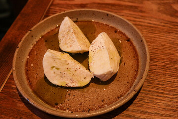 close up of mozzarella cheese in three quarter on a plate with copy space