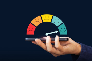 Excellent, positive feedback, service rating and satisfaction. A man holding mobile phone with rating feedback scale indicates the highest level of satisfaction with the service
