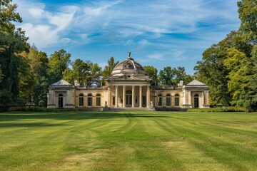 A grand pavilion rests amidst vibrant greenery under a clear blue sky, showcasing classic architecture in a peaceful garden setting during the afternoon.