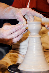 Hands Crafting Pottery On A Spinning Wheel In A Creative Workshop