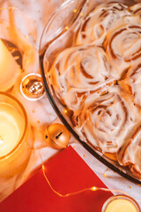 Christmas flatlay with cinnamon rolls and candles