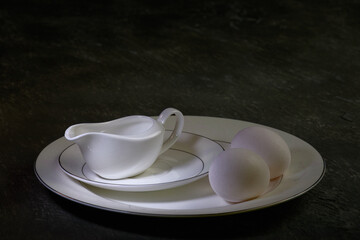 Still life: ceramic set of dishes and eggs.