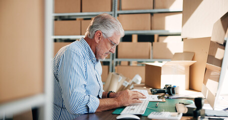 Senior man, typing and computer for distribution industry, inventory update and logistics information. Male person, boxes and ecommerce schedule with stock checklist, supply chain and order feedback