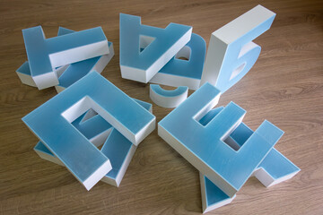 Three-dimensional light letters made of acrylic for advertising.Production of a logo for the store.