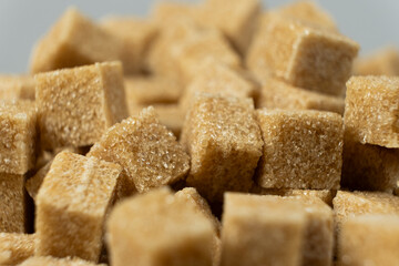 Macro cubes of brown cane unrefined demerara sugar.