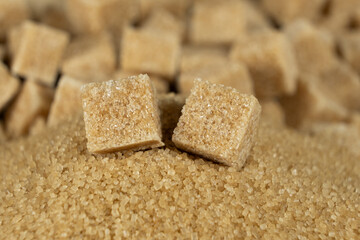 Brown cane unrefined demerara sugar in the form of crystals and cubes