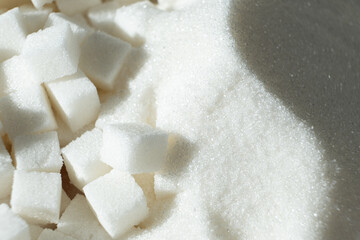 White refined beet sugar in the form of crystals and cubes.