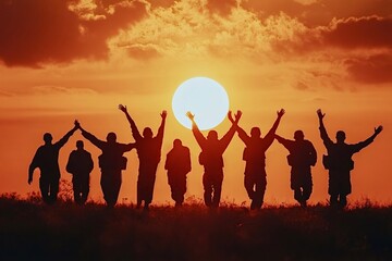 Fototapeta premium Soldiers celebrating victory at sunset raising arms up in the air