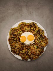 Zucchini and carrot pancakes with fried eggs for valentine's day