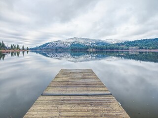 Dock on calm Rose Lake in Idaho.