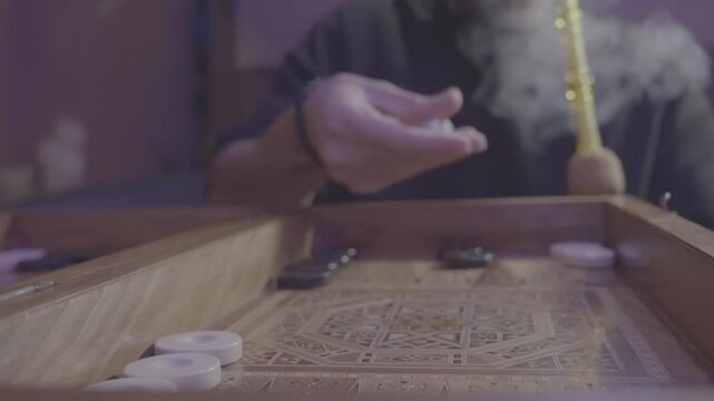 Man Rolling dices while smoking Shisha - V-Log