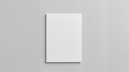 Blank white book cover on neutral background with subtle shadows