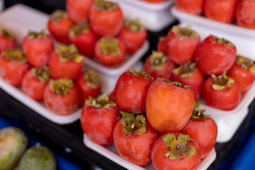 Vibrant Persimmons Piled High at a Local Bazaar
