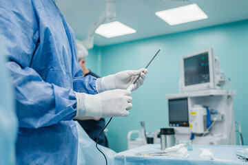 A skilled medical professional precisely prepares essential surgical instruments in a controlled...