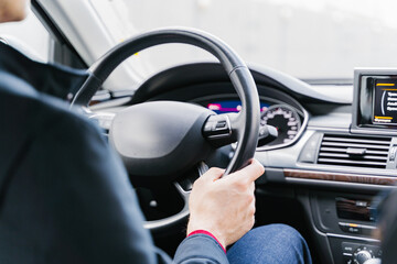 A person is driving a car with focused attention, concentrating on the road ahead of them