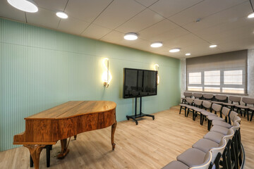 Music room with a grand piano and chairs