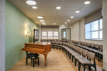 Music room with a grand piano and chairs