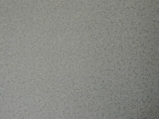 grey textured paper background with relief perforation with white and black abstract spots, graphic monochrome resource with empty copy space