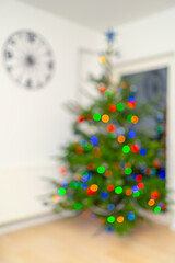 Defocused background with decorated New Year and Christmas tree with shining multi colored lights....